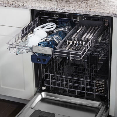 Open dishwasher with the third level rack pulled out and loaded