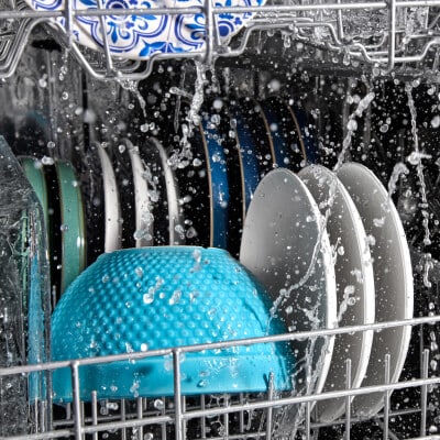 Plates and bowls being washed in a Maytag® dishwasher