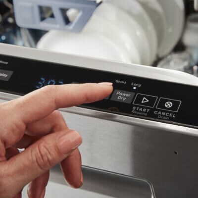 Person selecting the PowerDry® option on a Maytag brand dishwasher