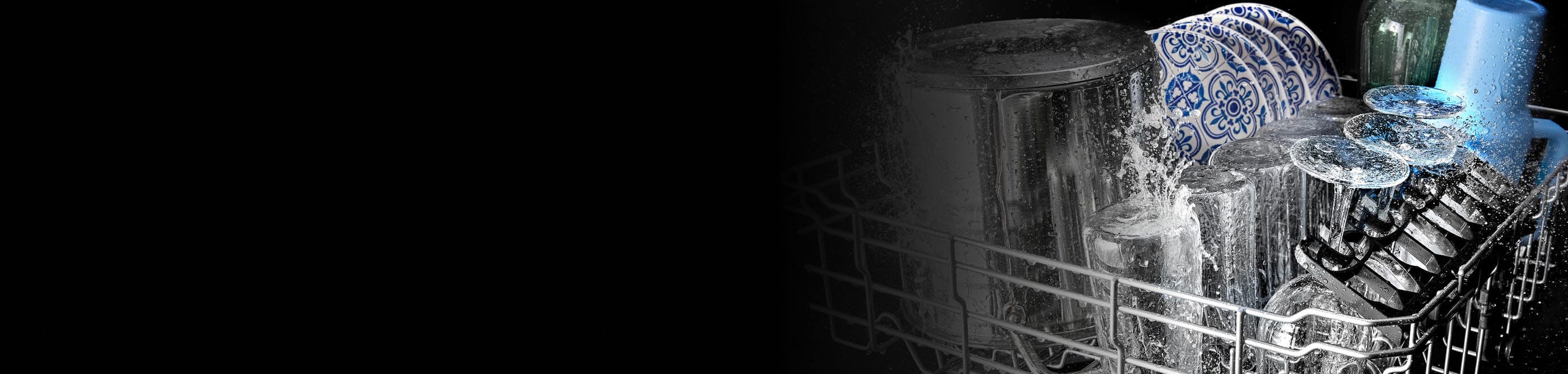 Glasses and plates being washed in a Maytag® dishwasher
