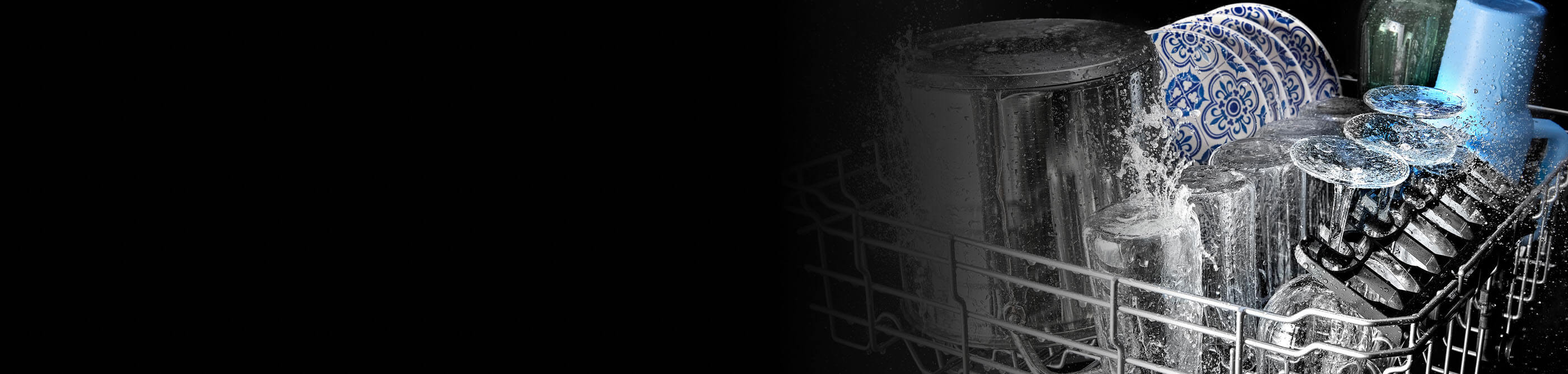 Glasses and plates being washed in a Maytag® dishwasher