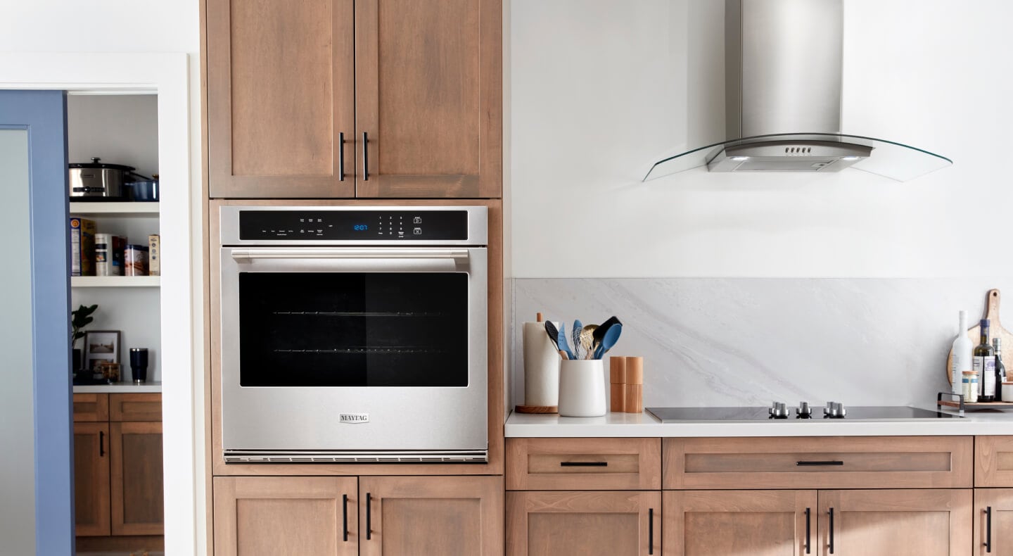 Single Maytag® wall oven in brown cabinetry Single Maytag® wall oven in brown cabinetry