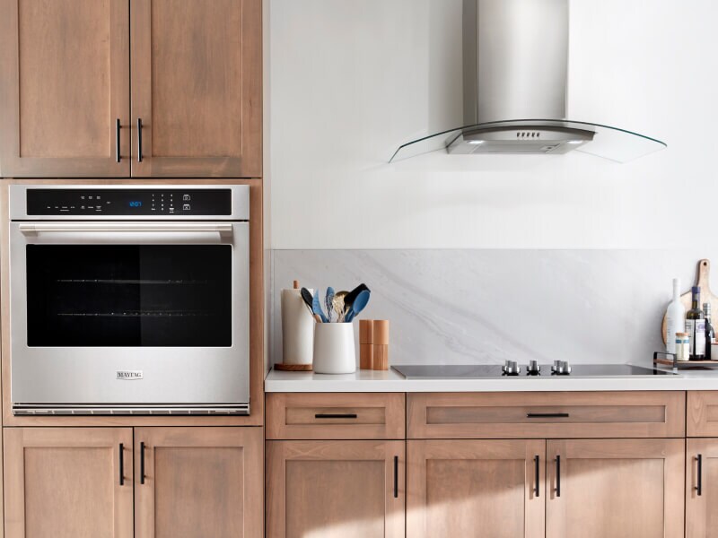 Single Maytag® wall oven in brown cabinetry Single Maytag® wall oven in brown cabinetry
