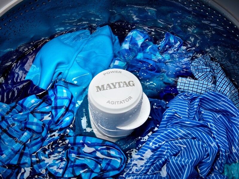 Blue clothes being washed in a Maytag® top-load washing machine Blue clothes being washed in a Maytag® top-load washing machine
