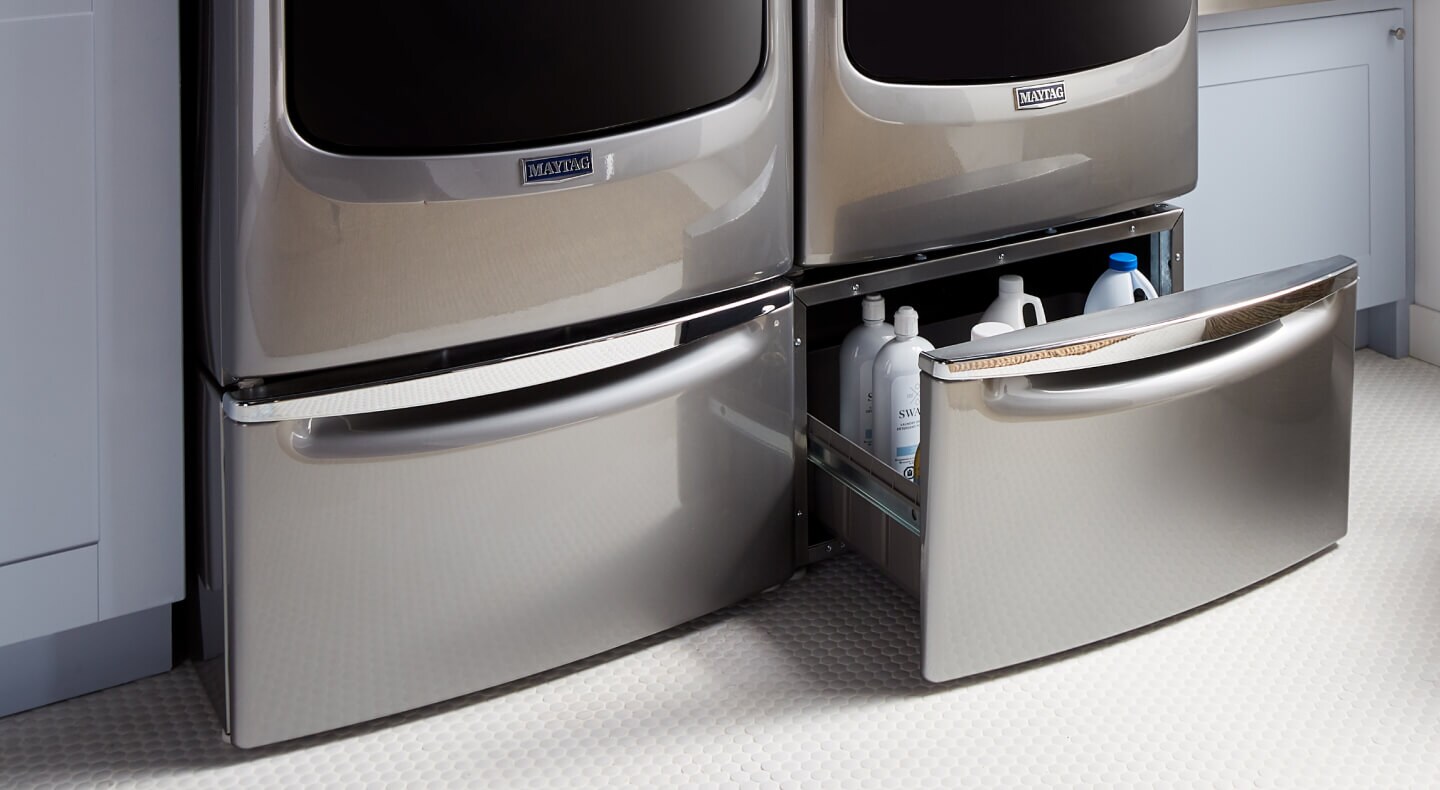 A close-up of laundry pedestals on a Maytag® washer and dryer pair