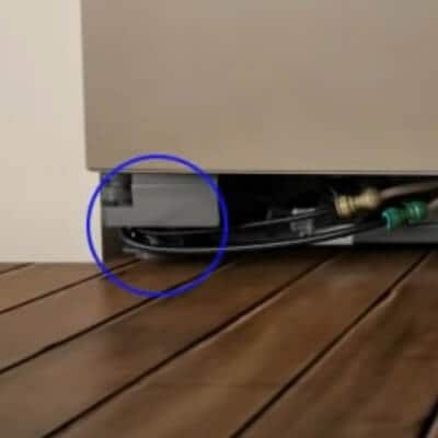 Close-up of leveling legs circled on one side of the refrigerator