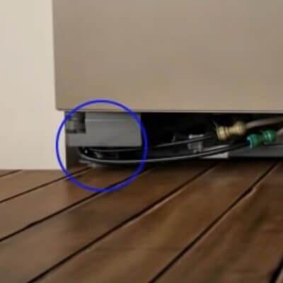 Close-up of leveling legs circled on one side of the refrigerator