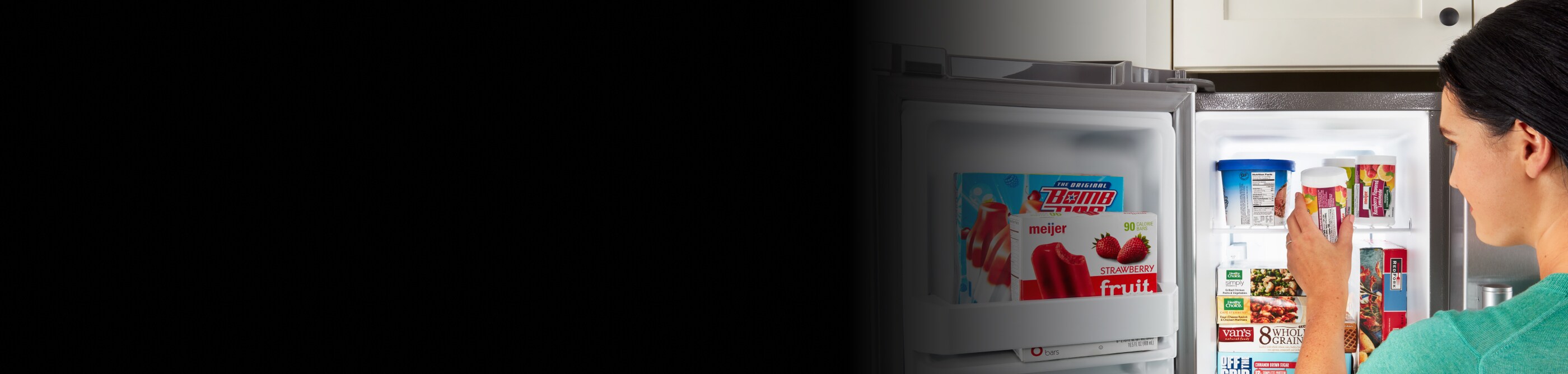  Person placing frozen goods into refrigerator freezer