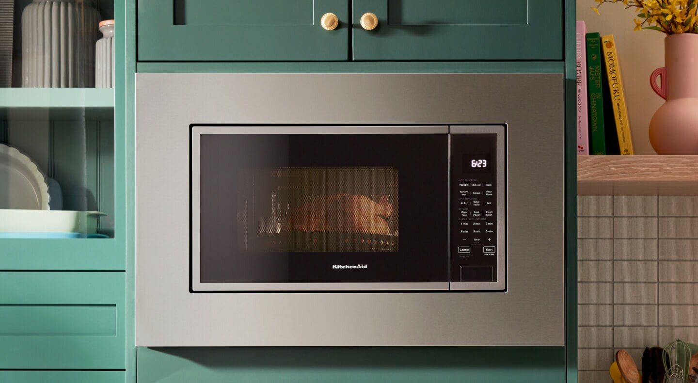 Over-the-range microwave surrounded by a trim kit