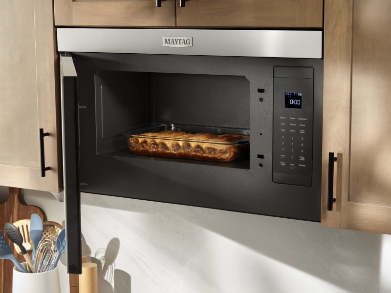 A Maytag® convection microwave baking a meal