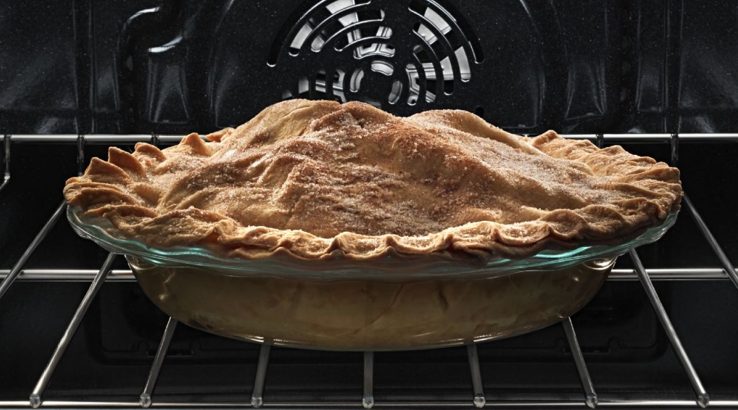 A pie baking in an oven. A pie baking in an oven.