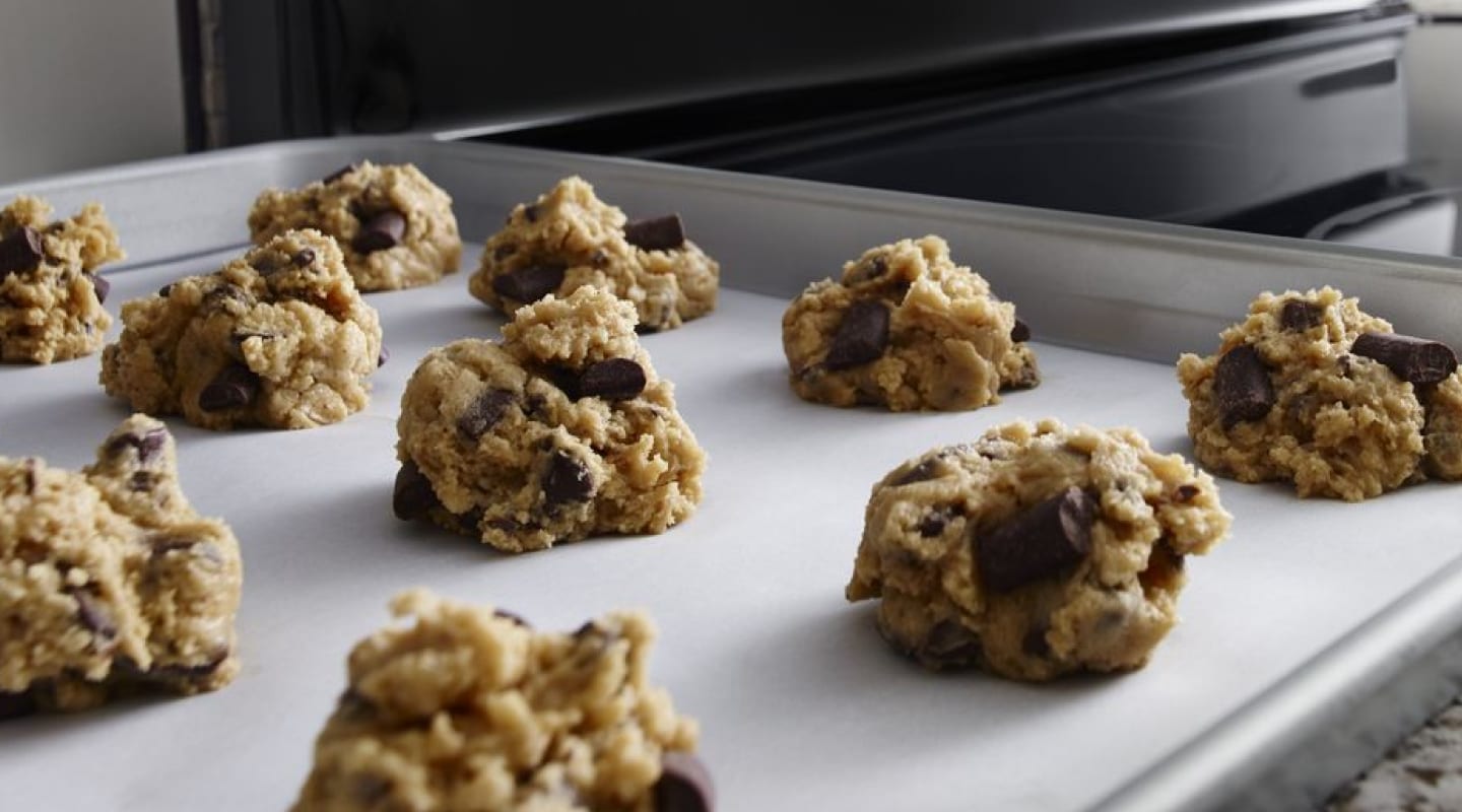 Cookie dough clusters on a baking sheet. Cookie dough clusters on a baking sheet.