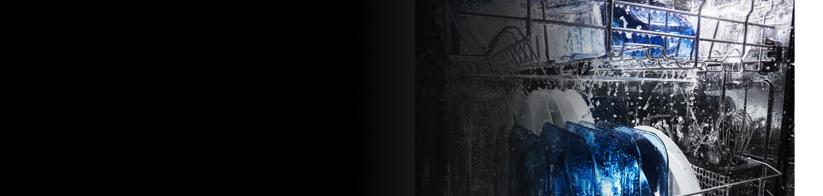 A load of dishes being washed on the racks of a dishwasher 