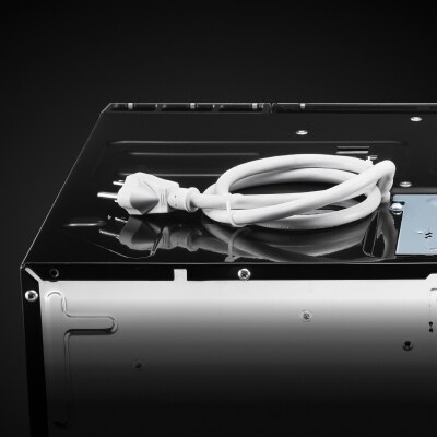 White power cord coiled on top of microwave