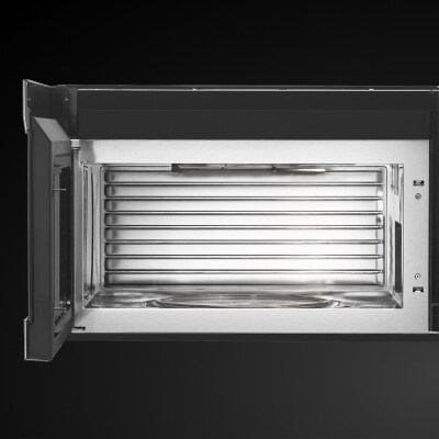 Door opened on microwave showing cooking cavity