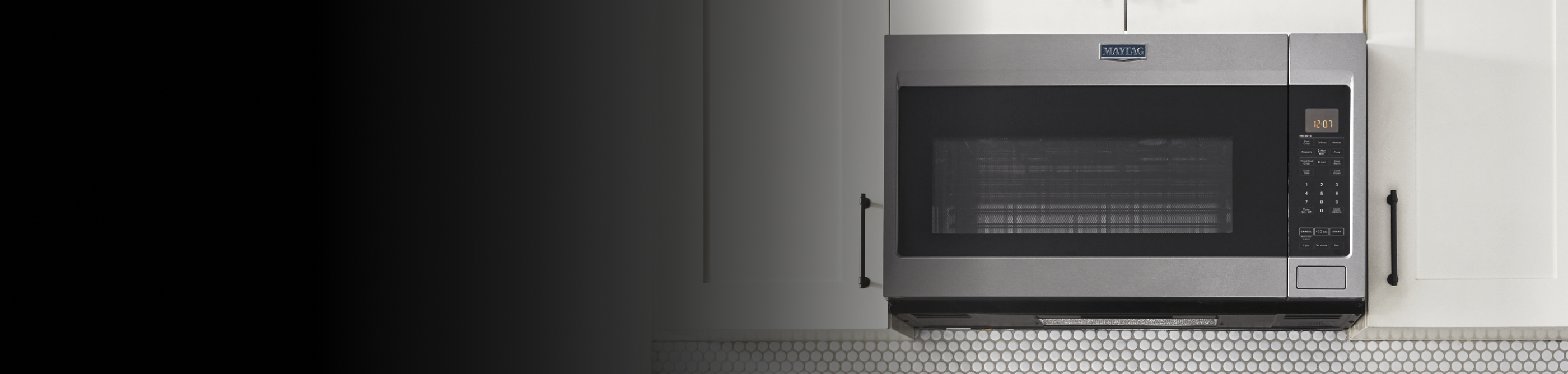 Stainless steel Maytag® over-the-range microwave set in white cabinetry