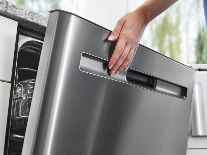 Hands on a dishwasher Hands on a dishwasher