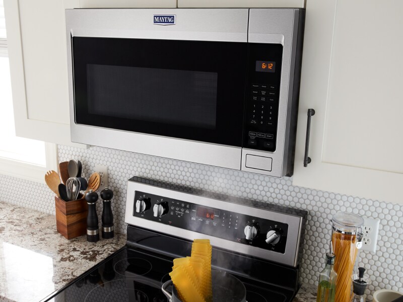 A Maytag® stainless steel over-the-range microwave in a modern kitchen A Maytag® stainless steel over-the-range microwave in a modern kitchen