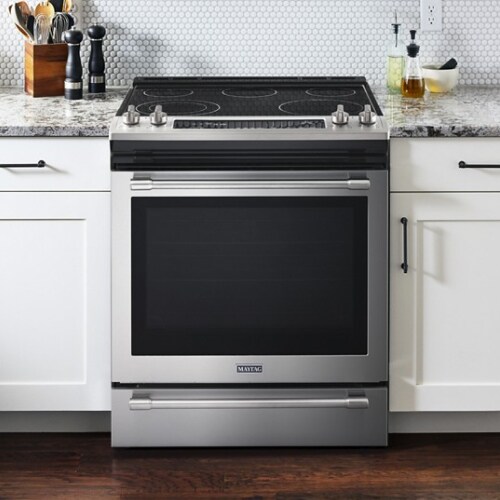 Slide-in electric range between cabinets