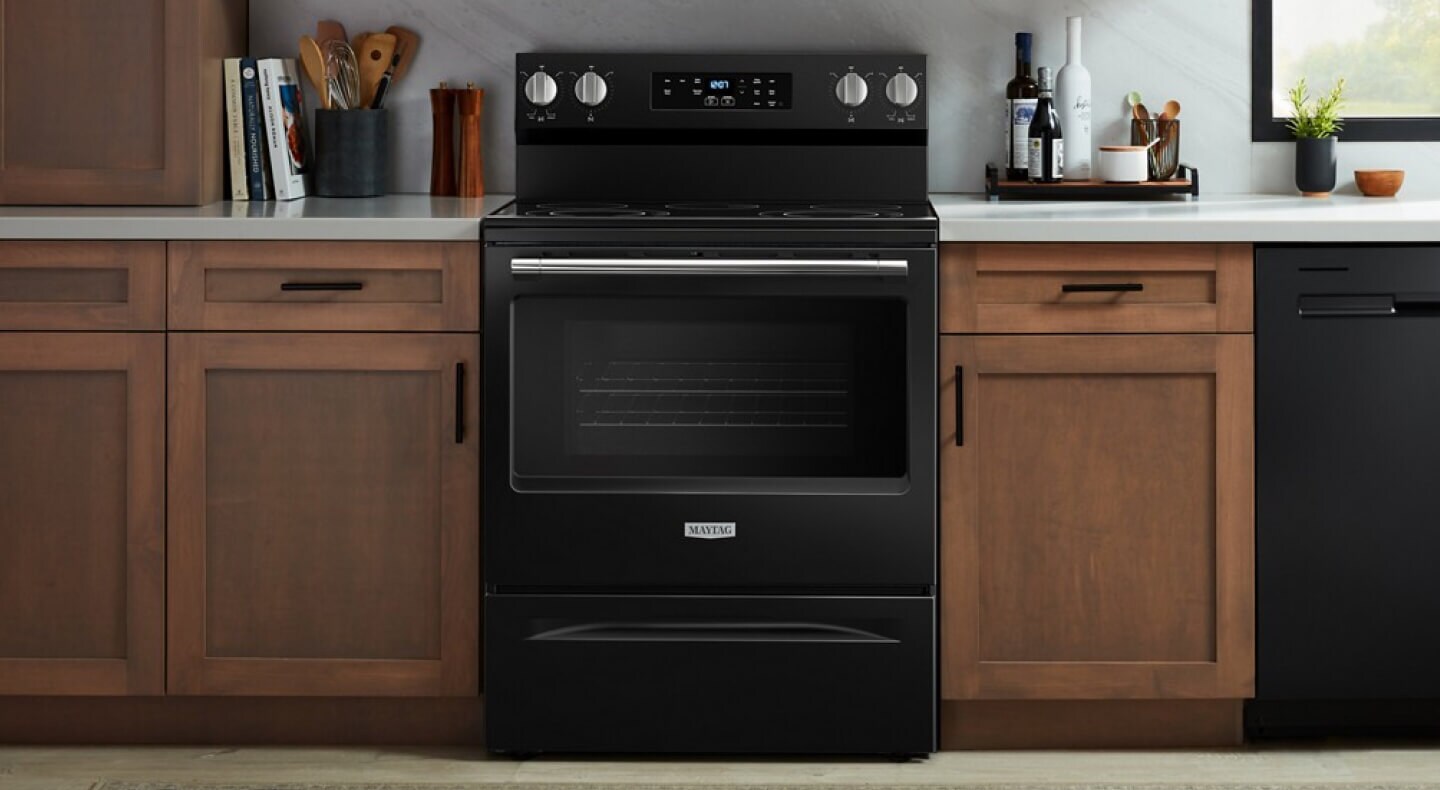 A Maytag brand slide-in range in a modern kitchen