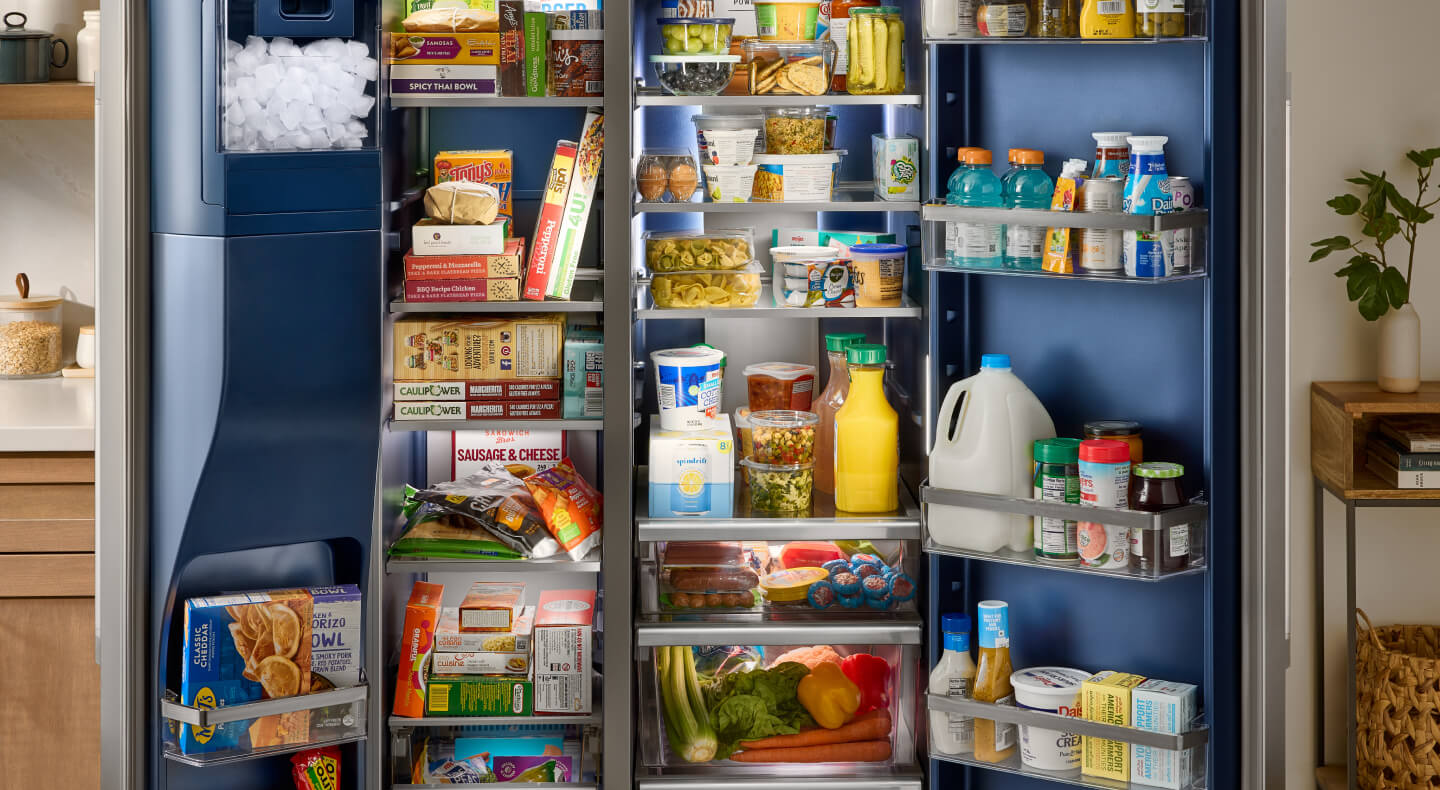 An open Maytag® side-by-side refrigerator with an Arctic Blue Interior
