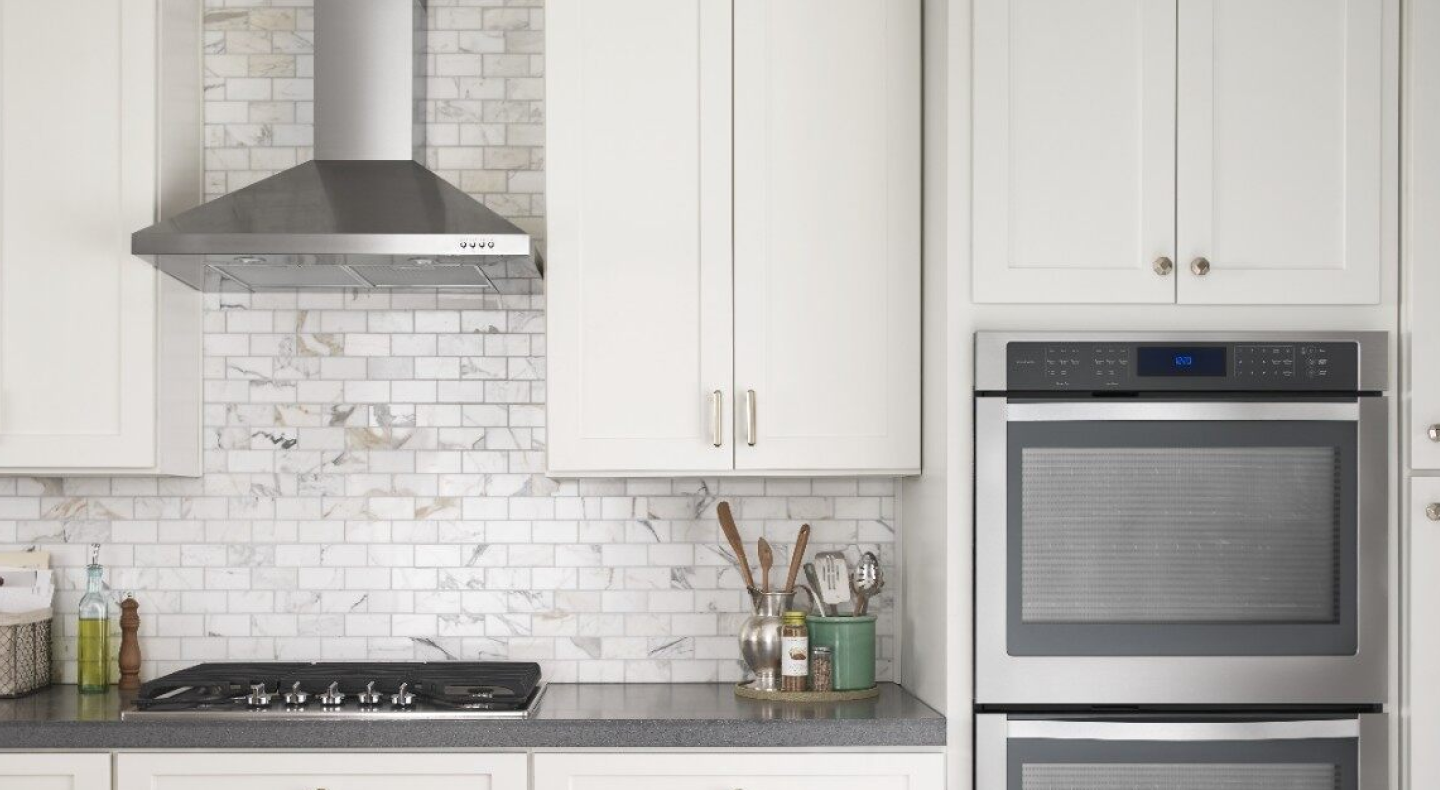 Stainless steel Maytag® range hood in a bright kitchen Stainless steel Maytag® range hood in a bright kitchen