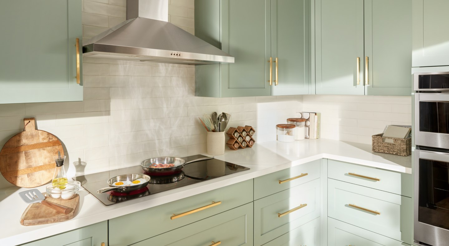Stainless steel Maytag® range hood in a light green kitchen Stainless steel Maytag® range hood in a light green kitchen