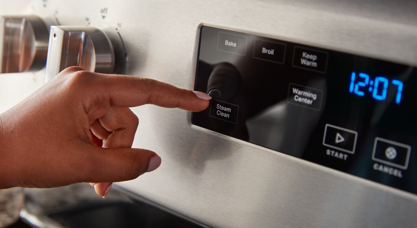 A person selecting a steam clean option A person selecting a steam clean option