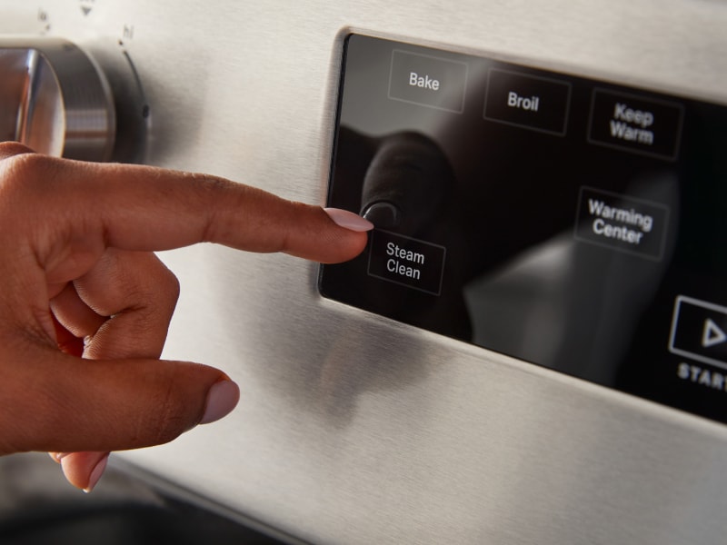 A person selecting a steam clean option A person selecting a steam clean option