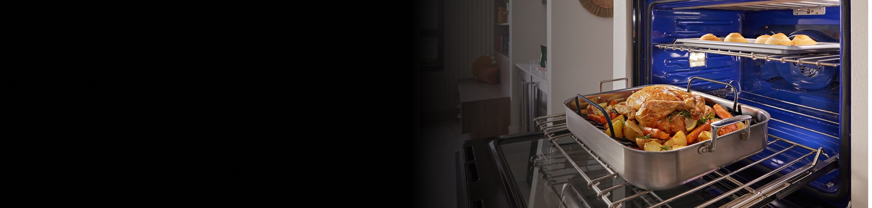 Poultry and veggies in a pan on an oven rack