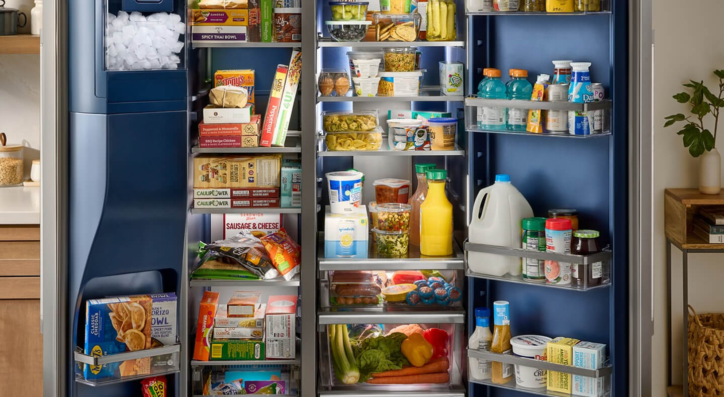 A side-by-side fridge, opened, full of colorful food
