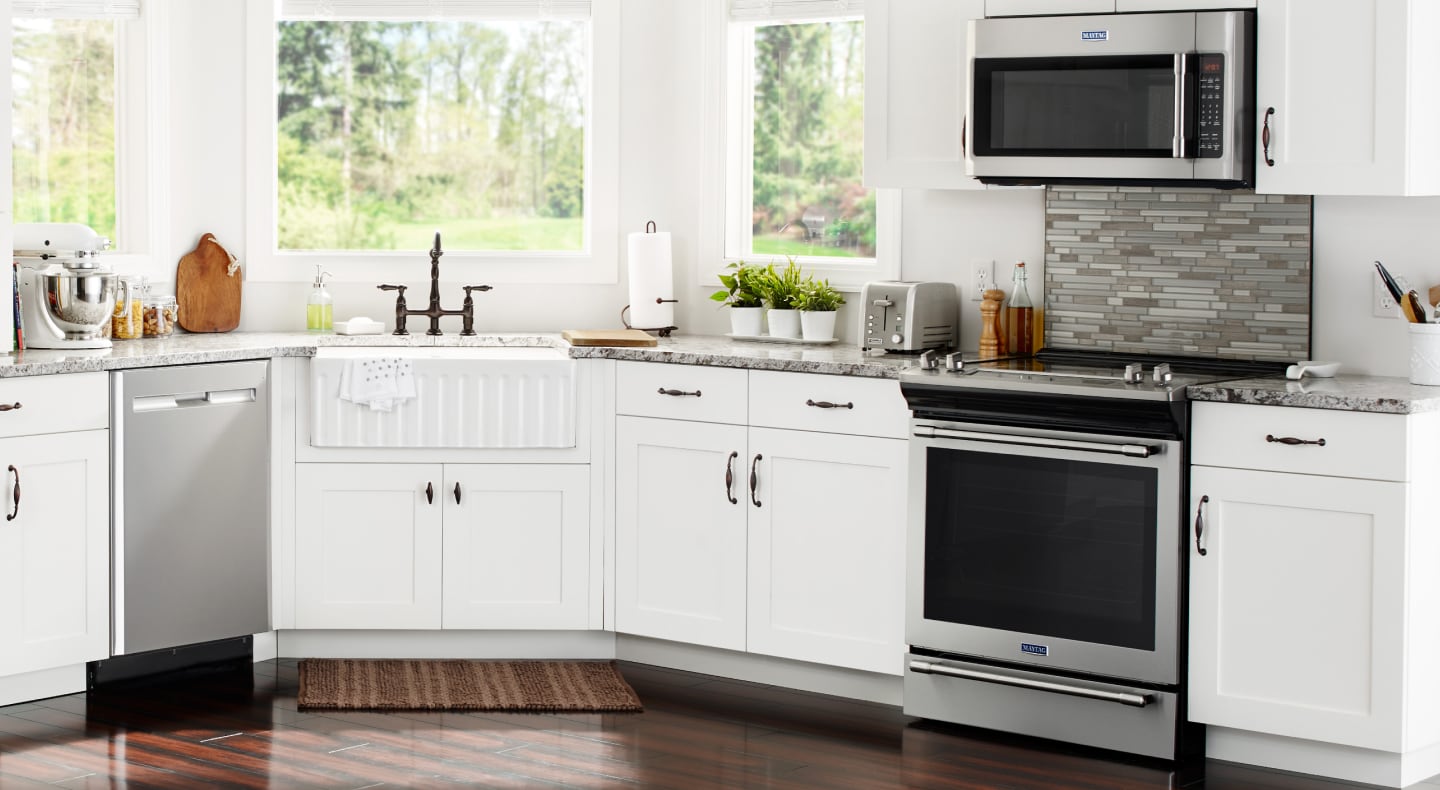 Various stainless steel appliances in a kitchen with white cabinetry Various stainless steel appliances in a kitchen with white cabinetry