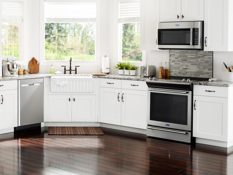 Various stainless steel appliances in a kitchen with white cabinetry Various stainless steel appliances in a kitchen with white cabinetry