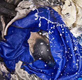 Laundry being washed in a top load washer