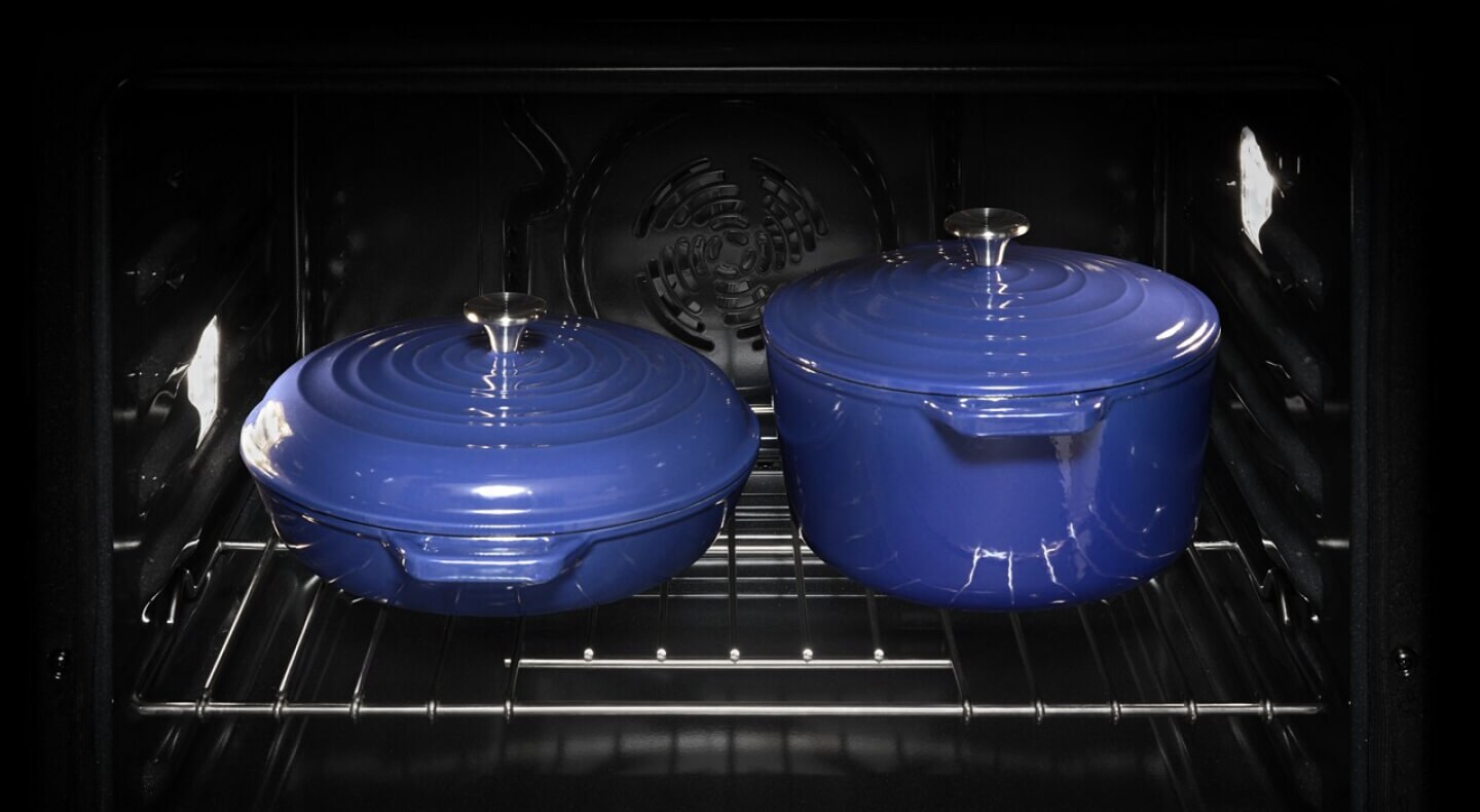 Two blue pots inside an oven
