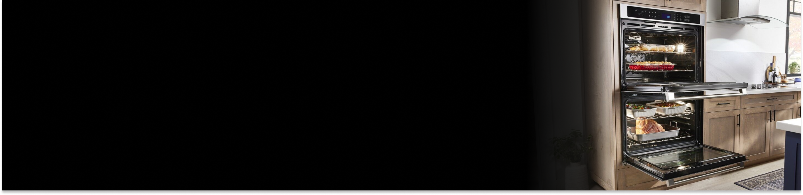 Double wall oven with open doors showing cooked dishes