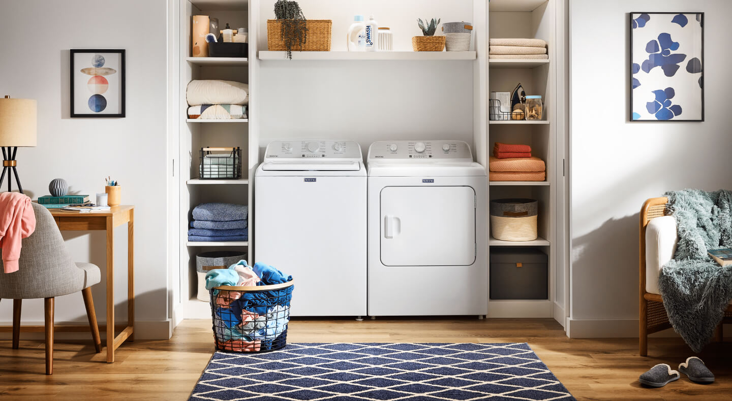 White Maytag® top load laundry pair in an open living space