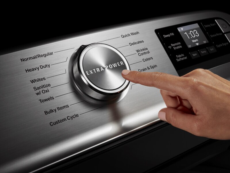 Person selecting Extra Power on a Maytag brand washer