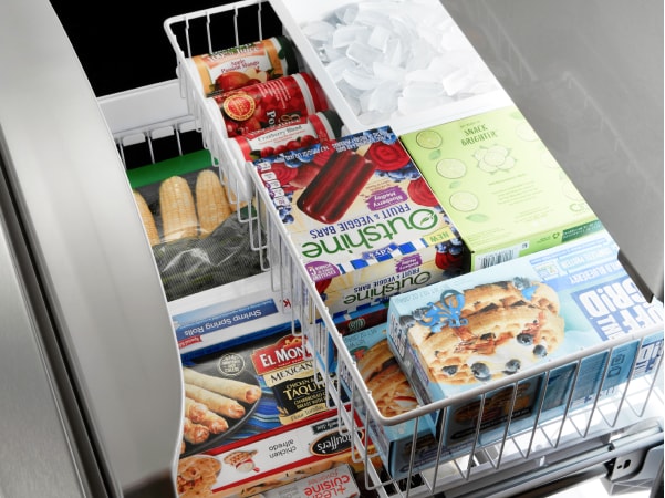 Drawer-style freezer stocked with frozen foods