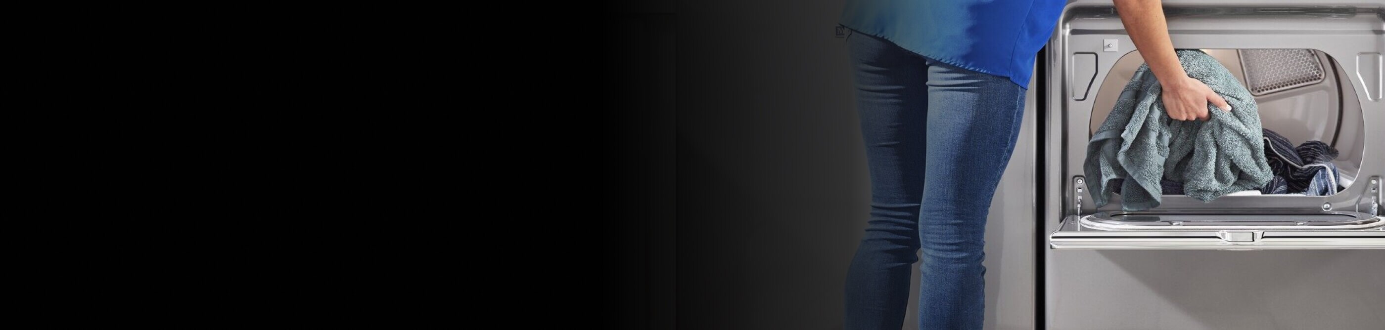 Person putting towels in a dryer