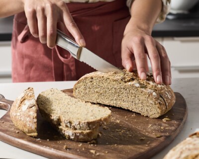 Person slicing bread