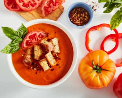 Tomato soup in a bowl with garnishes