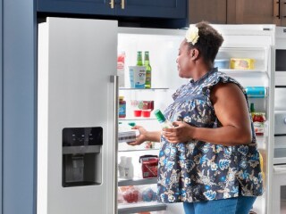 Person grabbing food from a French door refrigerator