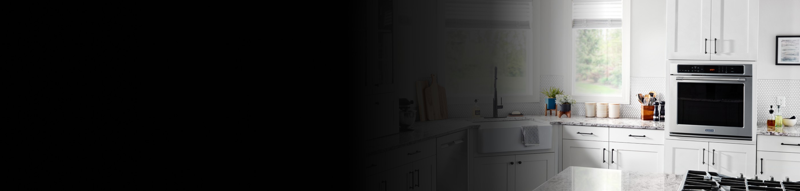 A wall oven in a white modern kitchen