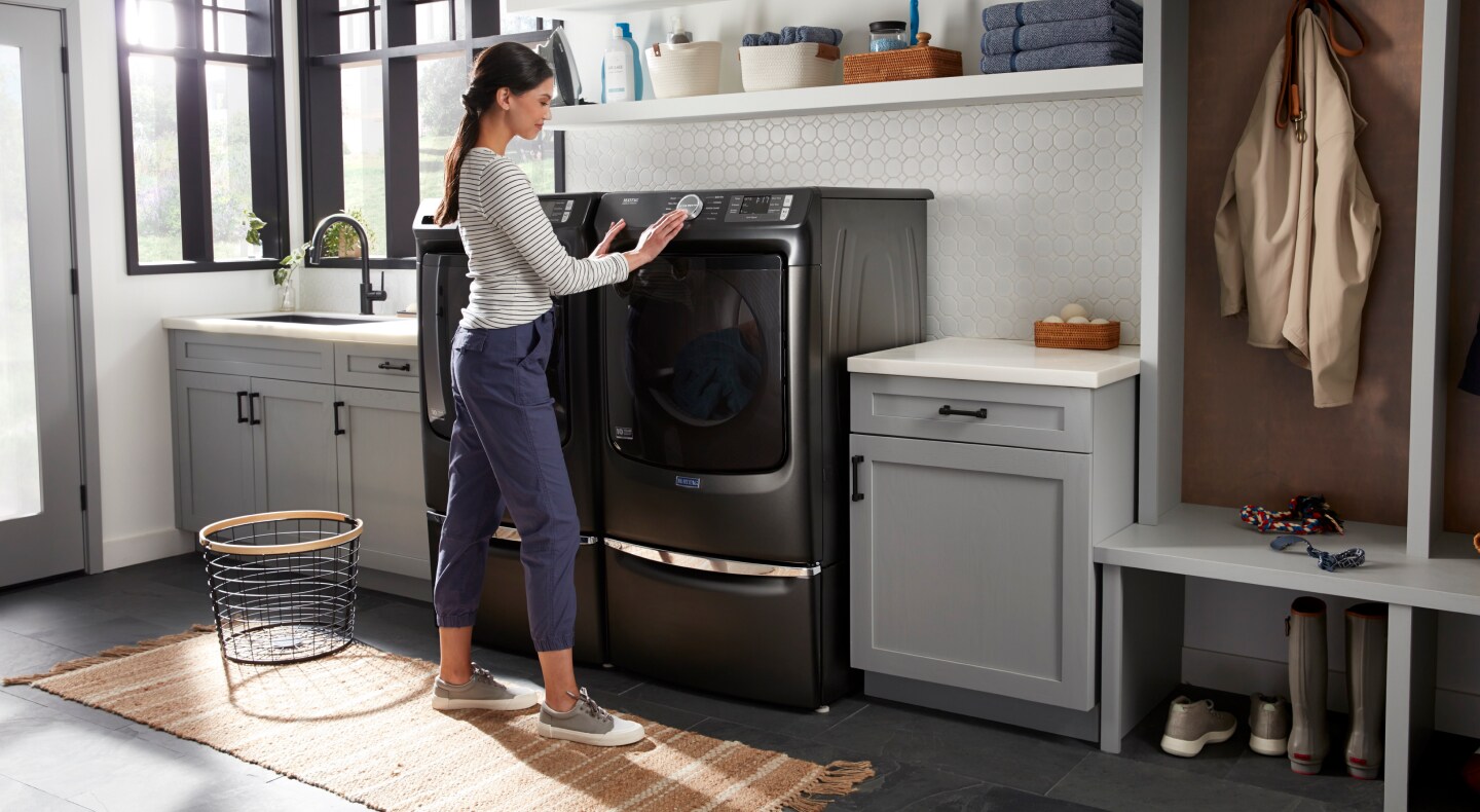 Person selecting a cycle on a Maytag® dryer Person selecting a cycle on a Maytag® dryer