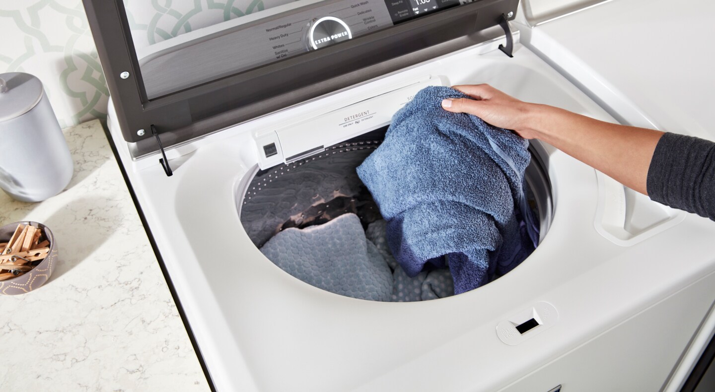 Person loading a washing machine