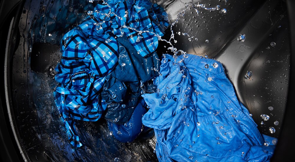A closeup of clothing washing in a washer tub A closeup of clothing washing in a washer tub