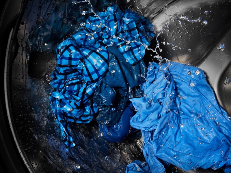 A closeup of clothing washing in a washer tub A closeup of clothing washing in a washer tub