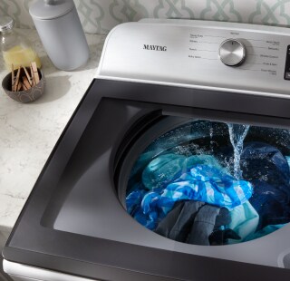 Maytag® washing machine with water pouring in