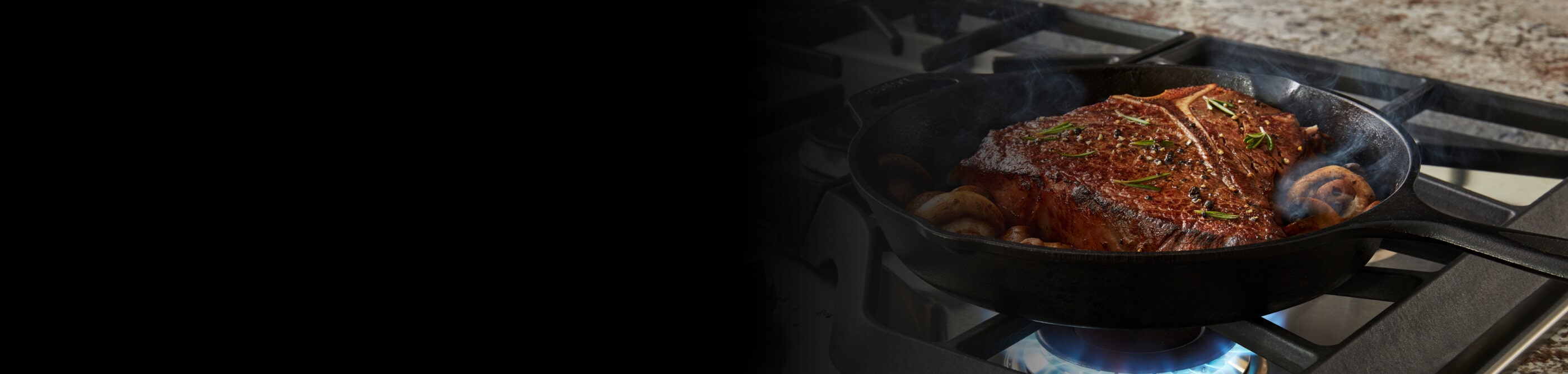 Steak cooking on a gas range